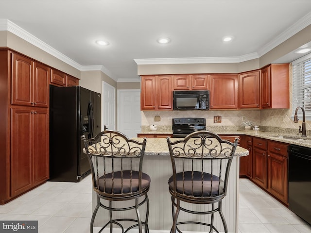 kitchen with light stone counters, sink, black appliances, and ornamental molding