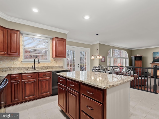 kitchen with french doors, hanging light fixtures, a healthy amount of sunlight, and sink