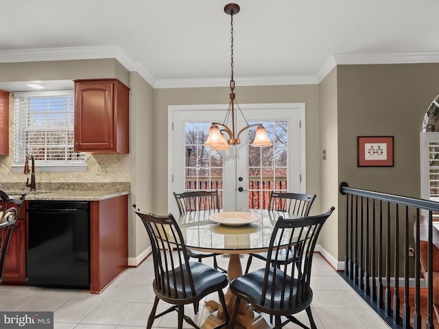 dining room featuring a wealth of natural light, crown molding, and an inviting chandelier