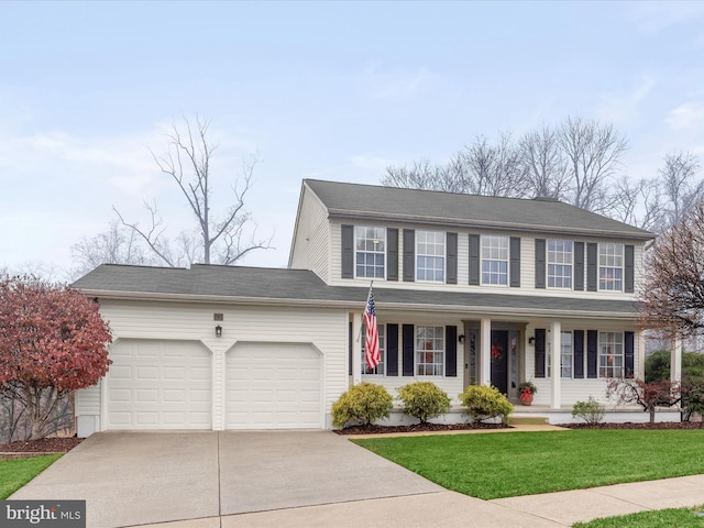 colonial-style house featuring a porch, a garage, and a front lawn