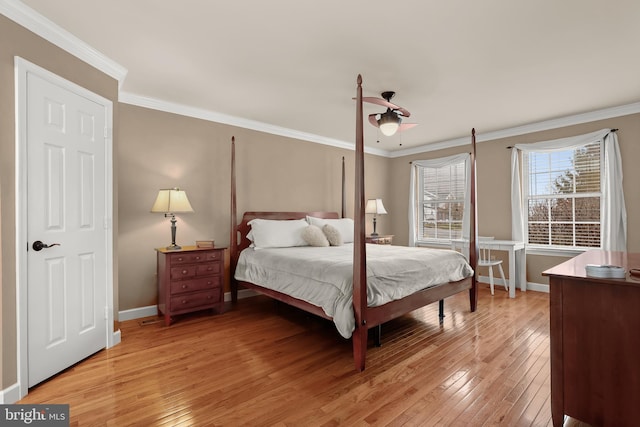 bedroom featuring light hardwood / wood-style flooring, ceiling fan, and ornamental molding