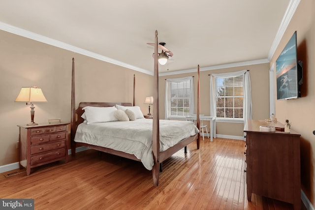 bedroom featuring ceiling fan, light hardwood / wood-style floors, and ornamental molding