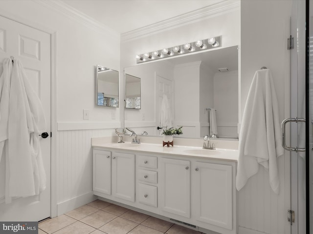 bathroom with tile patterned flooring, vanity, and crown molding