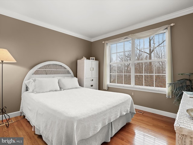 bedroom featuring wood-type flooring and crown molding