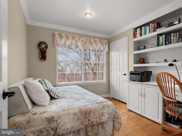 bedroom featuring light wood-type flooring and crown molding