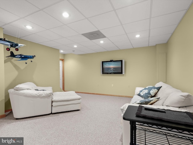 living room featuring carpet flooring and a drop ceiling