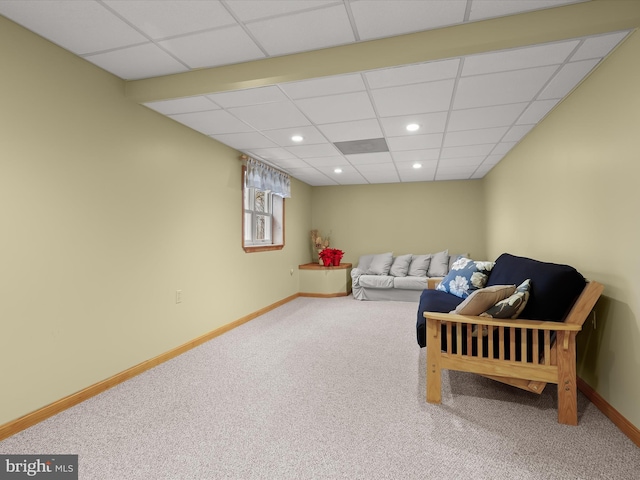 living room with carpet flooring and a drop ceiling