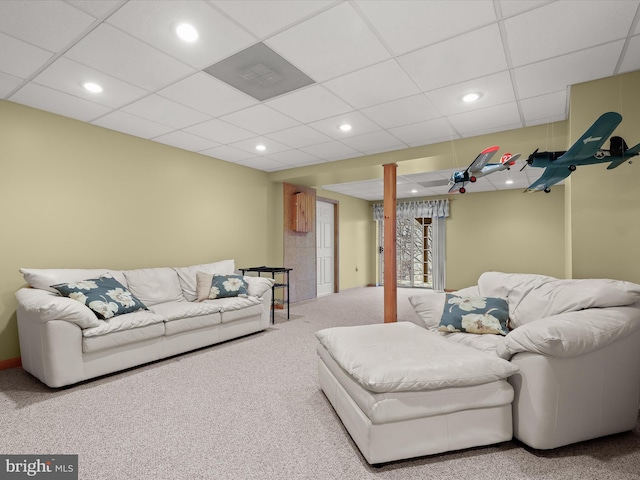 living room with carpet and a drop ceiling