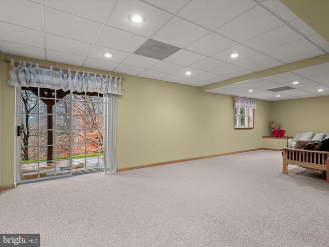 interior space featuring a drop ceiling and carpet floors