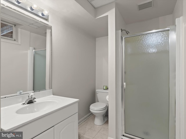 bathroom featuring toilet, vanity, tile patterned floors, and an enclosed shower