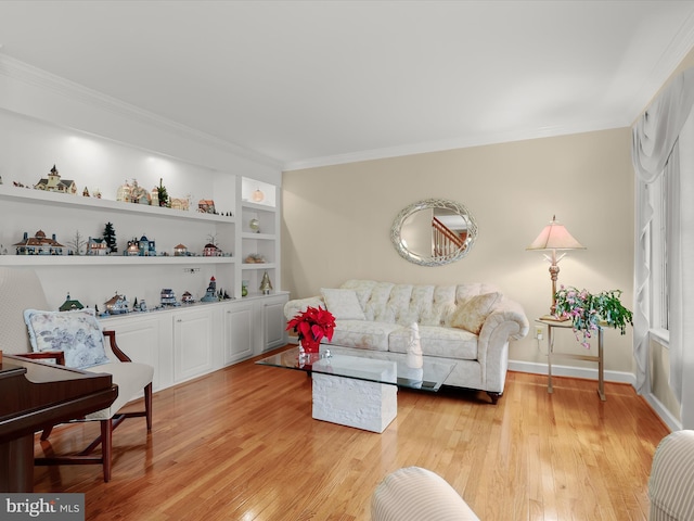 living room with light hardwood / wood-style flooring, built in features, and ornamental molding