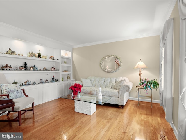 living room featuring crown molding and light hardwood / wood-style flooring