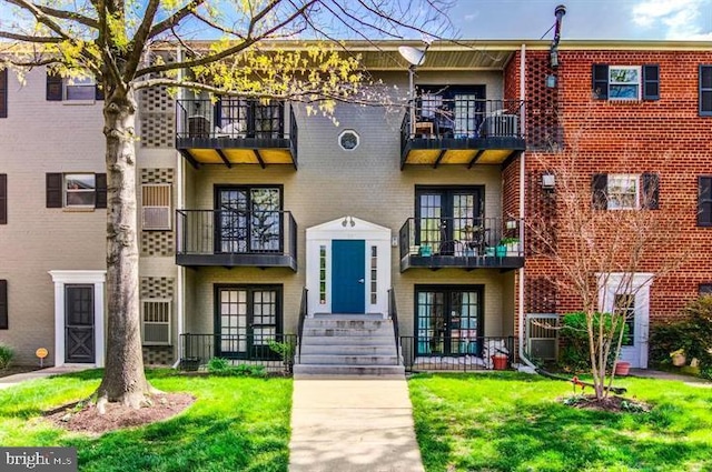 townhome / multi-family property featuring a front yard and french doors