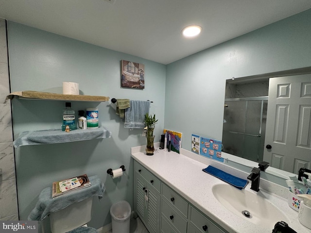 bathroom featuring vanity and a shower with door