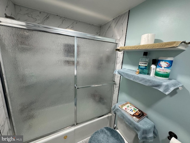 bathroom featuring shower / bath combination with glass door