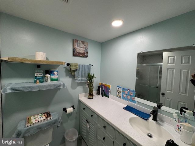 bathroom with a shower with door and vanity