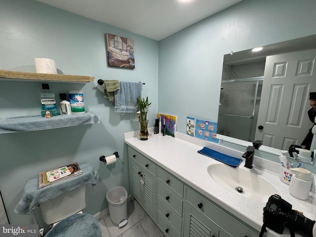 bathroom with vanity and a shower with shower door