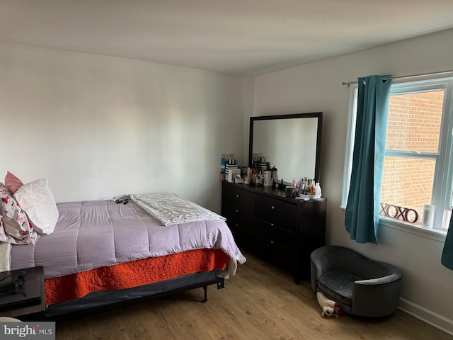 bedroom with hardwood / wood-style flooring