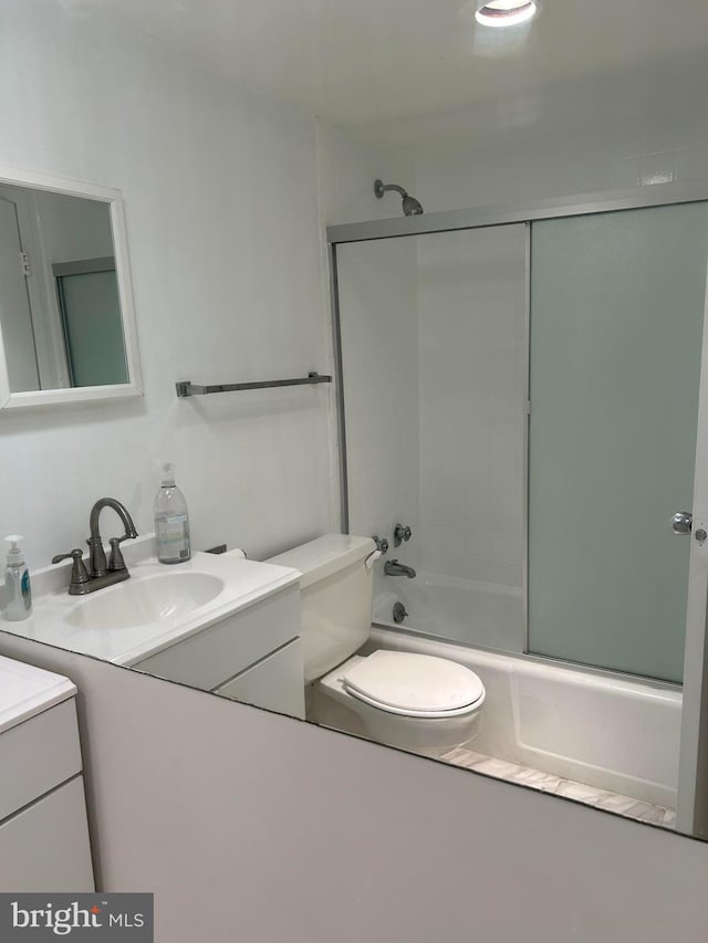 full bathroom with vanity, toilet, and bath / shower combo with glass door