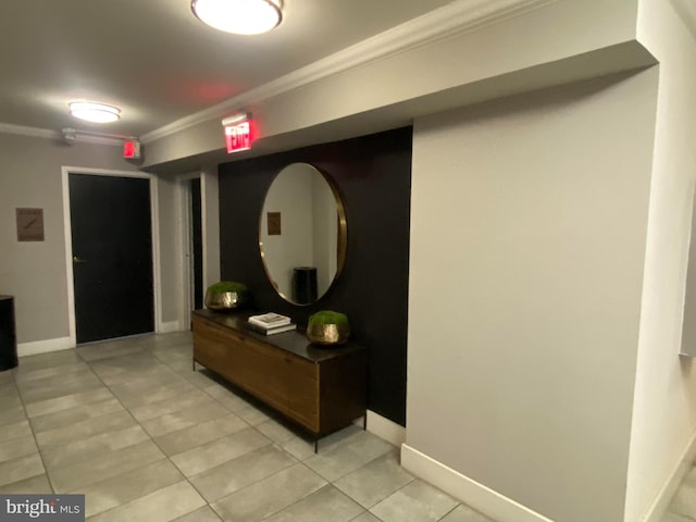 hallway with light tile patterned floors and crown molding