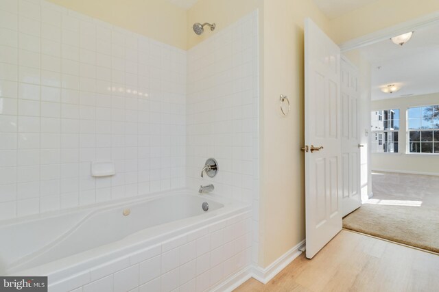 45512 Westmeath Unit B21, Great Mills, MD 20634 - bathroom featuring wood finished floors, baseboards, and shower / tub combination