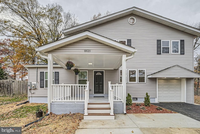 view of front of property with covered porch and a garage