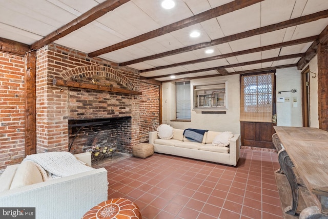 living room with beam ceiling, a fireplace, and tile patterned flooring