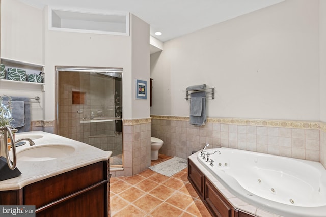 full bathroom with tile patterned floors, vanity, toilet, and independent shower and bath