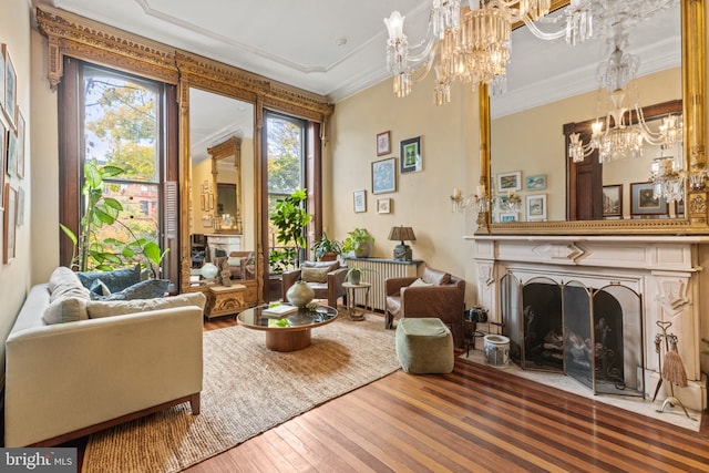 interior space with hardwood / wood-style floors, crown molding, and a notable chandelier