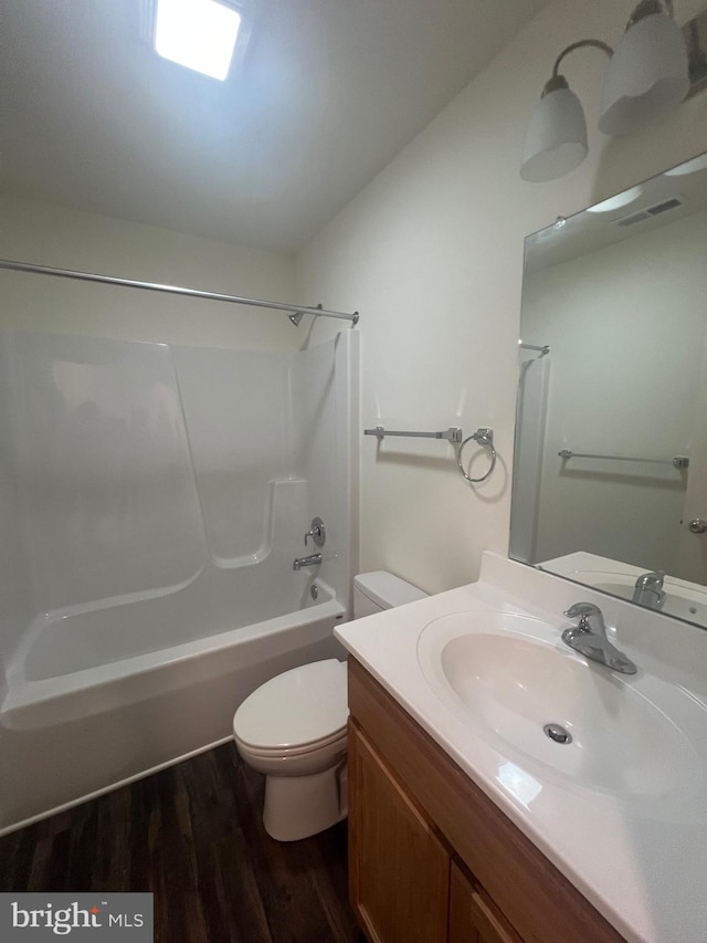 full bathroom featuring shower / washtub combination, toilet, vanity, and hardwood / wood-style flooring