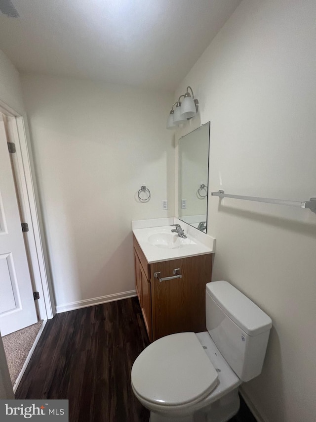 bathroom featuring hardwood / wood-style floors, vanity, and toilet