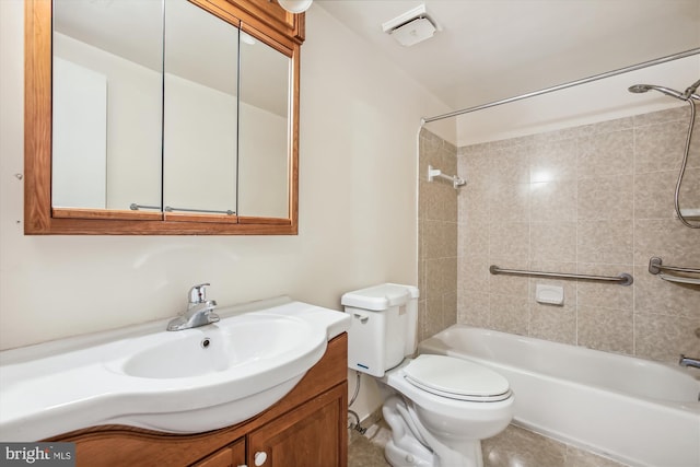 full bathroom featuring tile patterned flooring, tiled shower / bath combo, toilet, and vanity