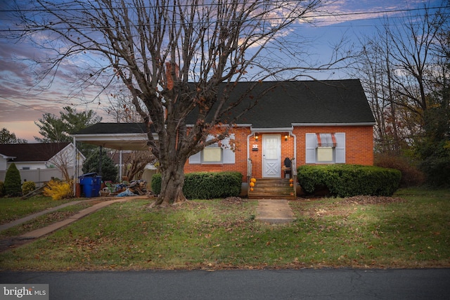 view of front facade featuring a yard and a carport