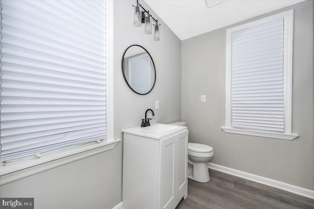 bathroom featuring toilet, vanity, and hardwood / wood-style flooring