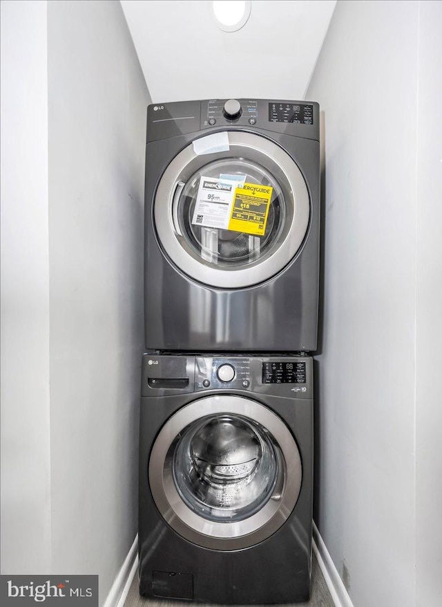 laundry room with stacked washer / dryer