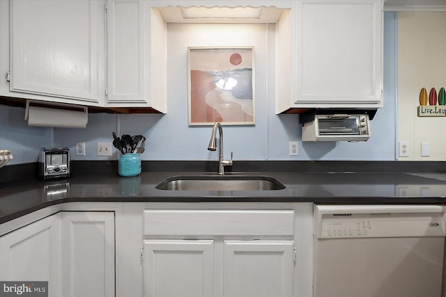 kitchen with dishwasher, white cabinetry, and sink