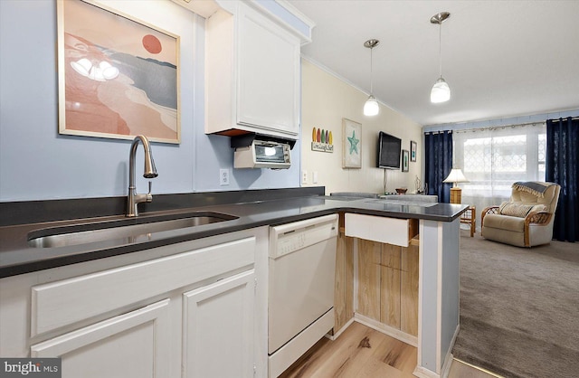 kitchen with dishwasher, white cabinets, sink, decorative light fixtures, and light hardwood / wood-style floors