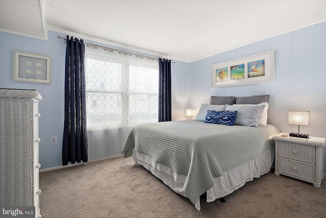 bedroom featuring carpet, a textured ceiling, and ornamental molding