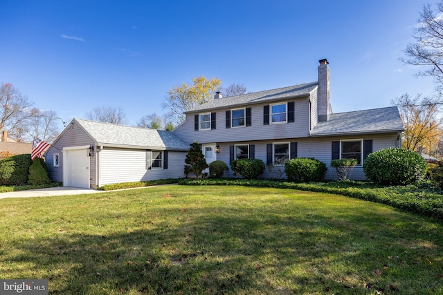 view of front of property with a front yard and a garage