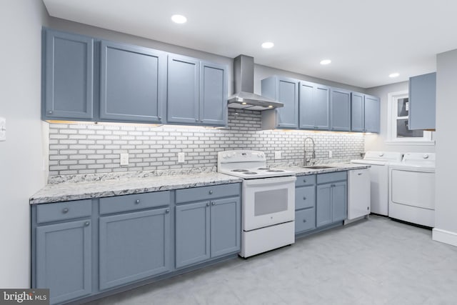 kitchen with decorative backsplash, wall chimney exhaust hood, white electric range oven, sink, and washing machine and dryer