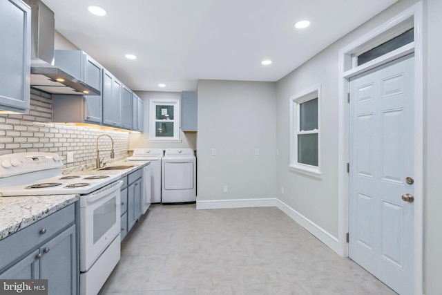 kitchen with backsplash, wall chimney range hood, sink, electric range, and washer and dryer