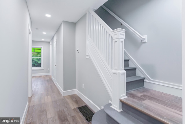 staircase featuring wood-type flooring