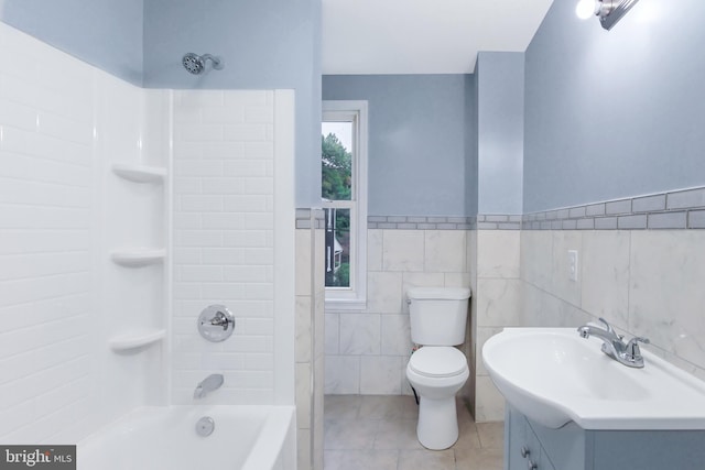 full bathroom featuring tile patterned flooring, shower / bath combination, tile walls, and toilet