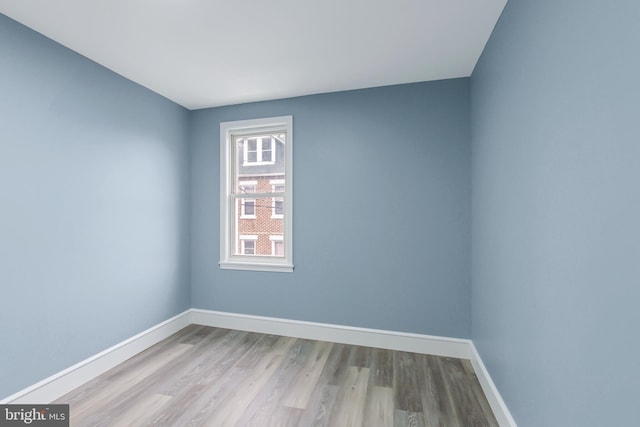 empty room with light hardwood / wood-style flooring