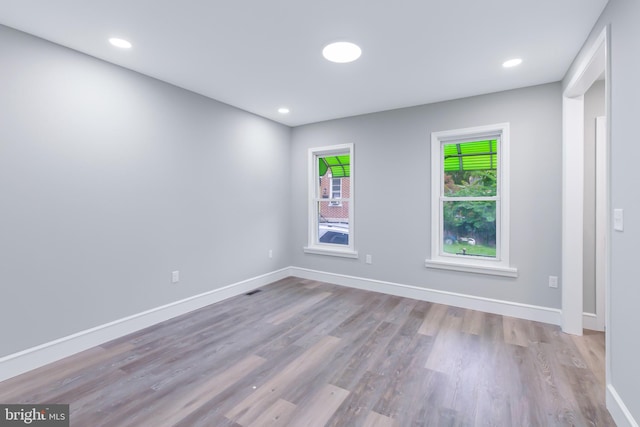 empty room with light hardwood / wood-style floors