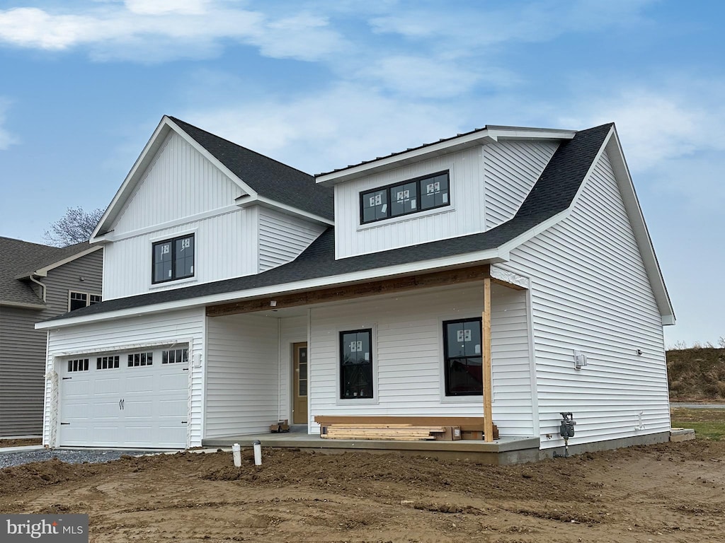 view of front facade featuring a porch and a garage