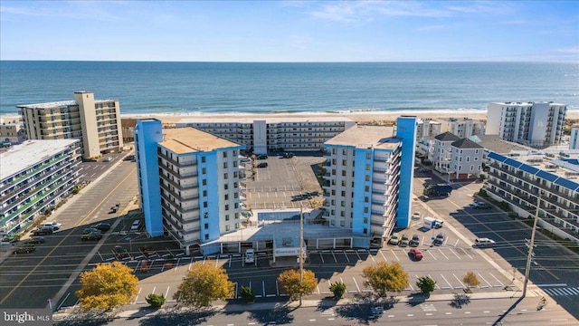 drone / aerial view featuring a water view and a view of the beach