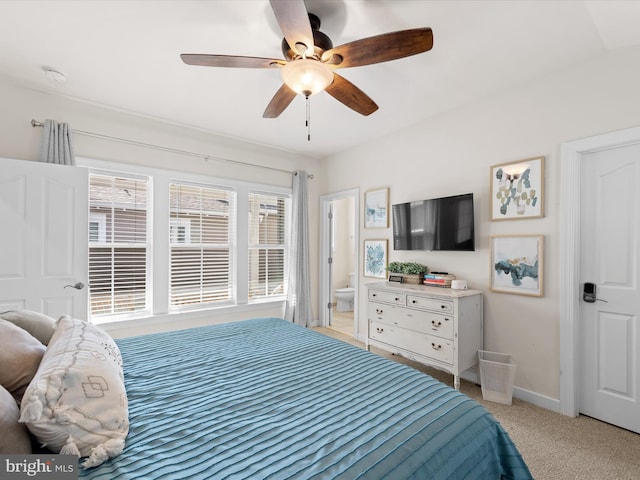 carpeted bedroom with ceiling fan and connected bathroom