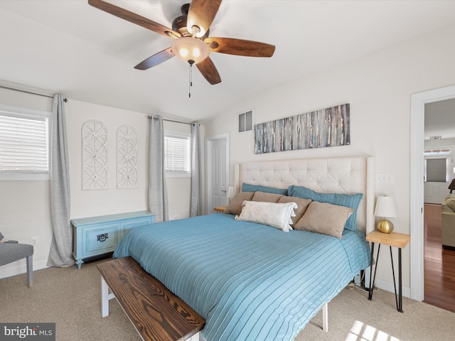 carpeted bedroom with ceiling fan and lofted ceiling