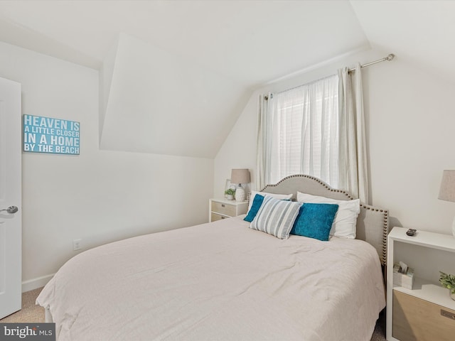 bedroom featuring carpet flooring and vaulted ceiling